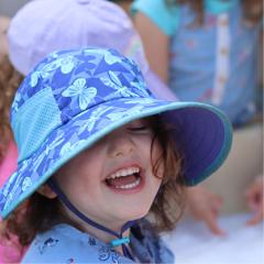 preschool age girl in hat smiling