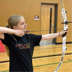 Girl taking aim in archery practice