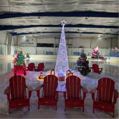 Image of 4 red chairs and white Christmas tree at JDF Arena