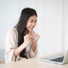 Lady looking at a computer screen looking excited